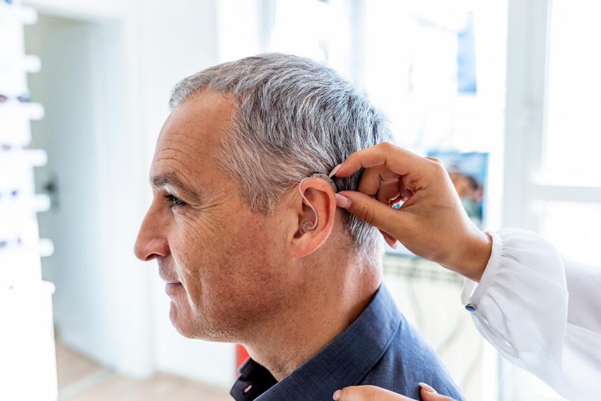 Senior with hearing aid