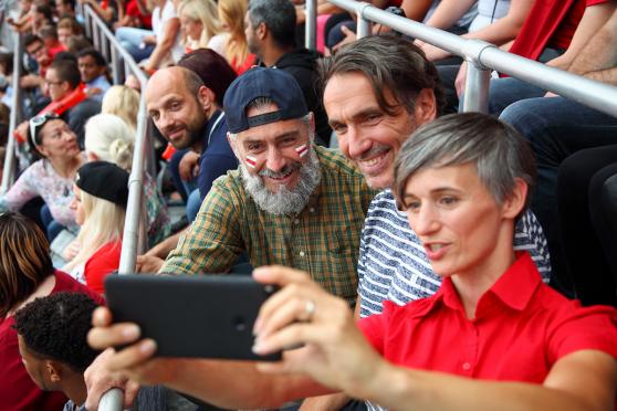 A group of friends taking a selfie at a sports stadium