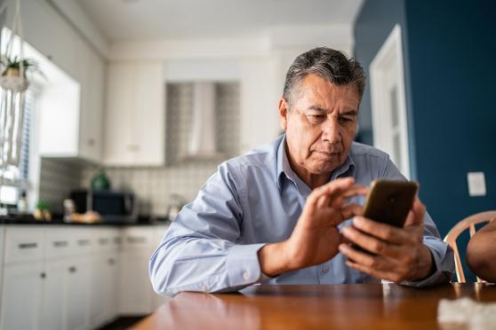 A man scrolling through a smartphone