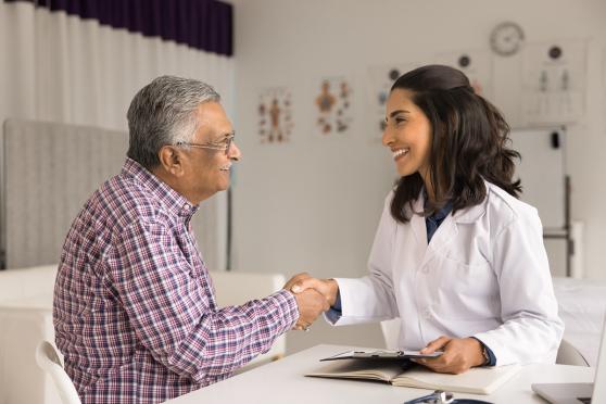 Doctor shaking hands with senior patient